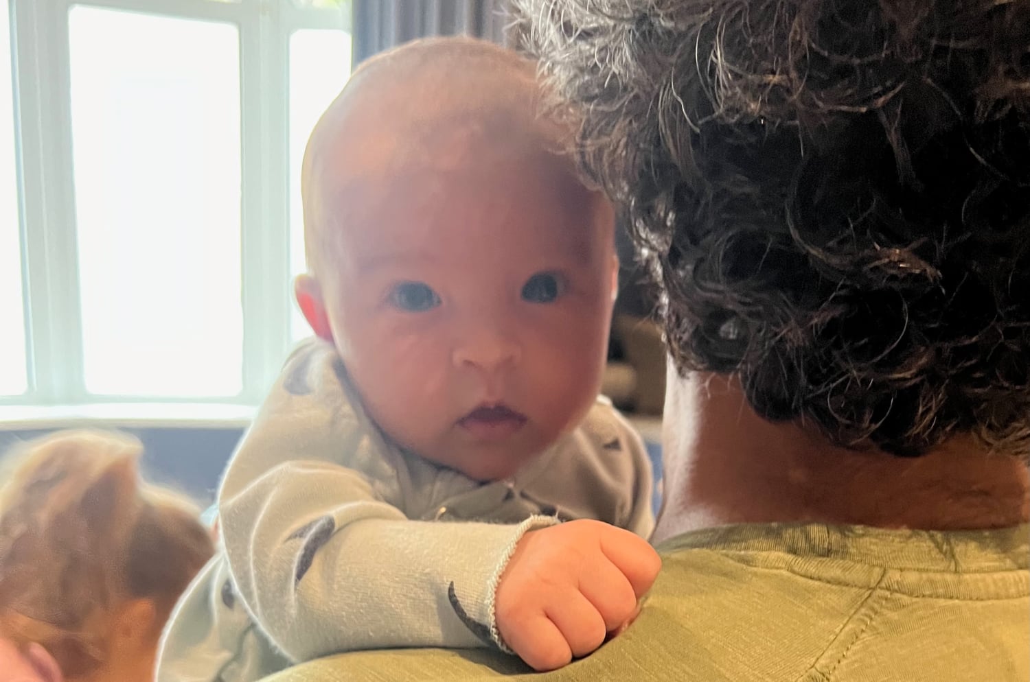 A picture of a baby looking at the camera